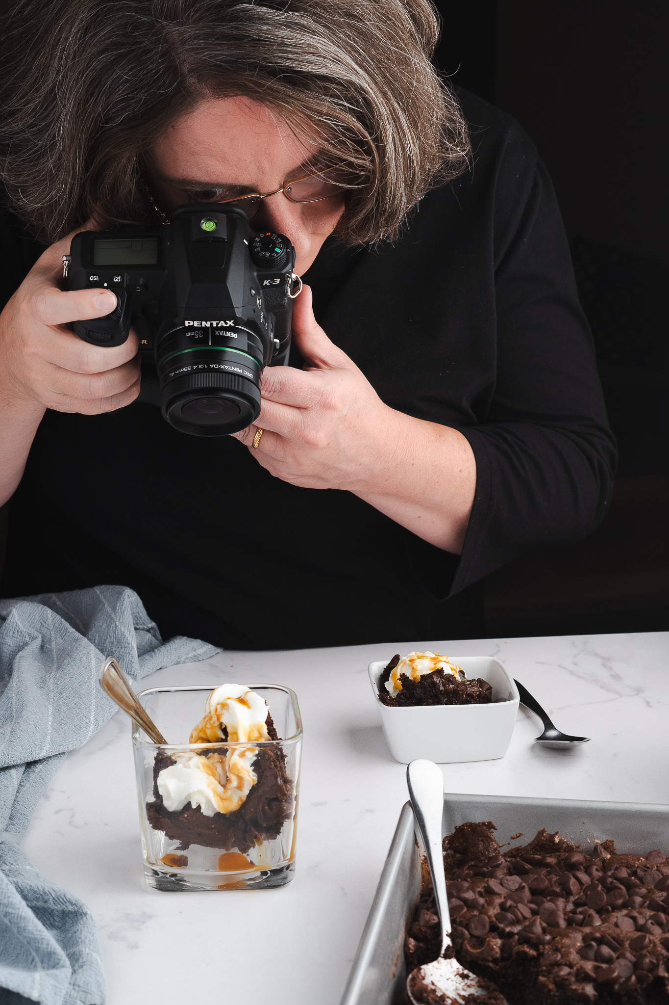 Heather Kitchen photographing a styled dessert in studio setup
