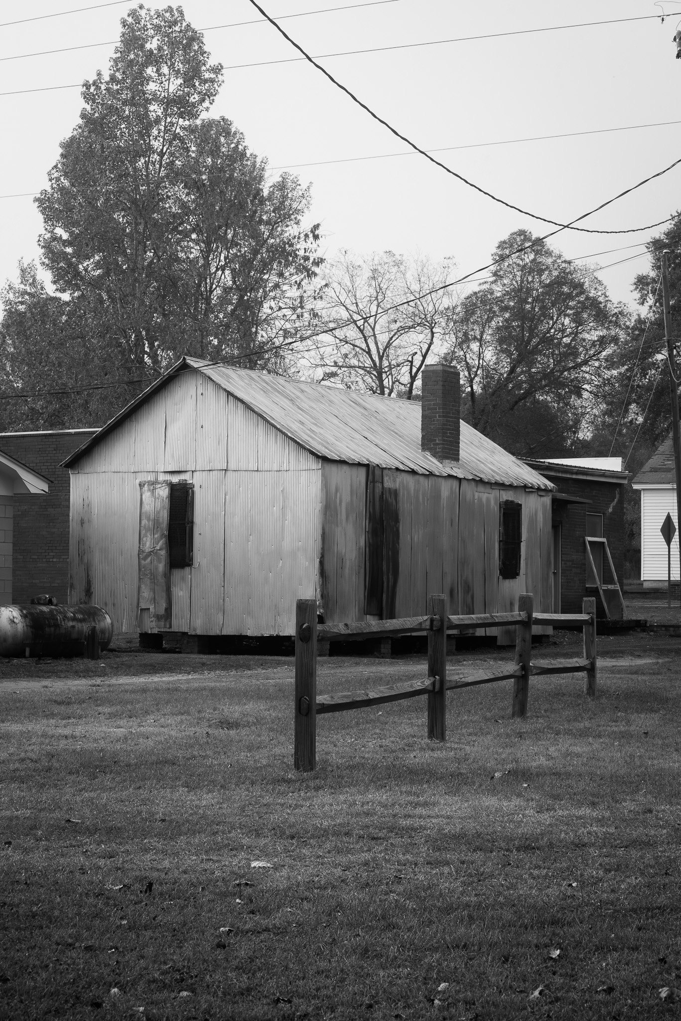 Black and white photograph of an unmarked, unused building in Pomaria, South Carolina, near Main Street and the Palmetto Trail.